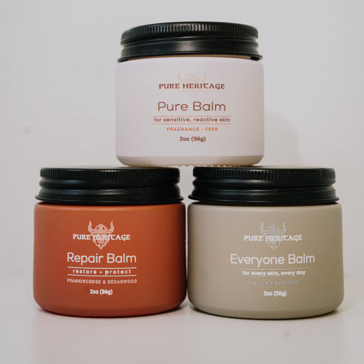 Three jars of Pure Heritage balms on a white background