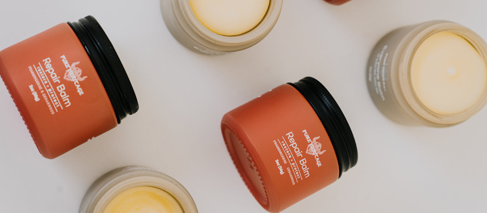 Multiple jars of Pepper Balm on a white background